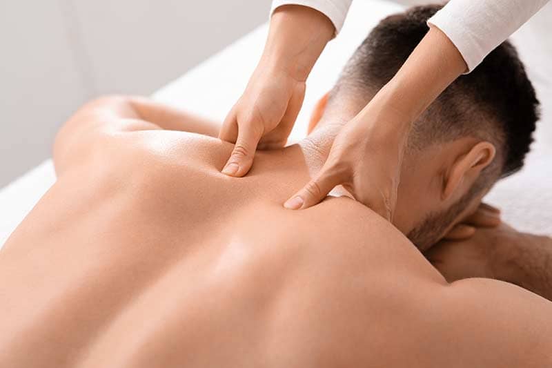 Man getting Reiki healing acupressure massage.